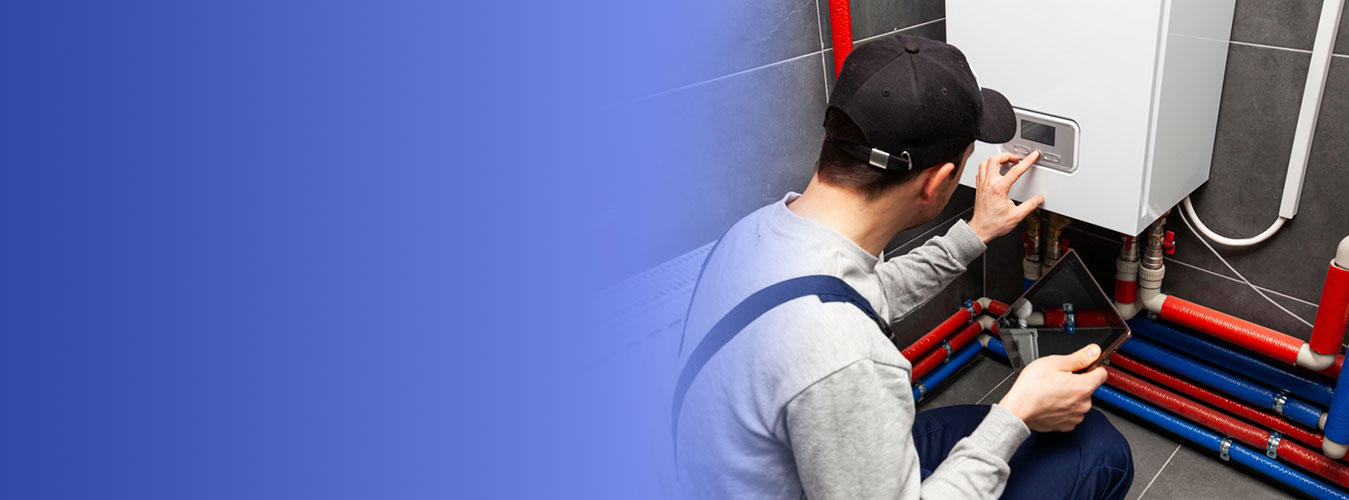 A technician servicing a residential water heater, the annual maintenance that keeps a Navien tankless water heater warranty valid